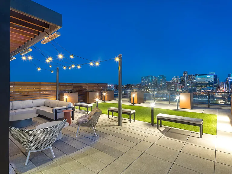 Rooftop deck with lush landscaping, fire pits, outdoor tv, plus city and mountain views.