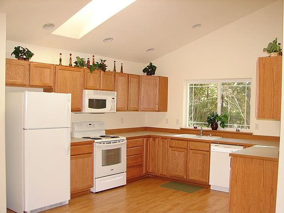 Kitchen w/ lots of cabinets & skylight.