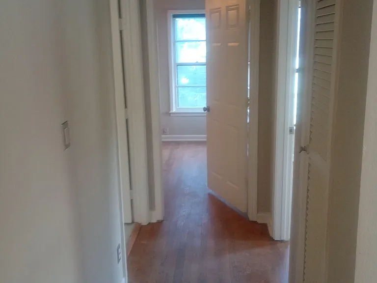 Main hallway to Master bedroom, 2nd bedroom, and guest bath with original hardwood flooring.
