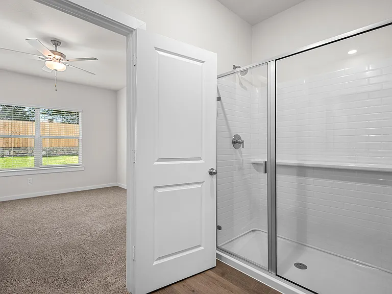 The master bathroom has a glass, walk-in shower.