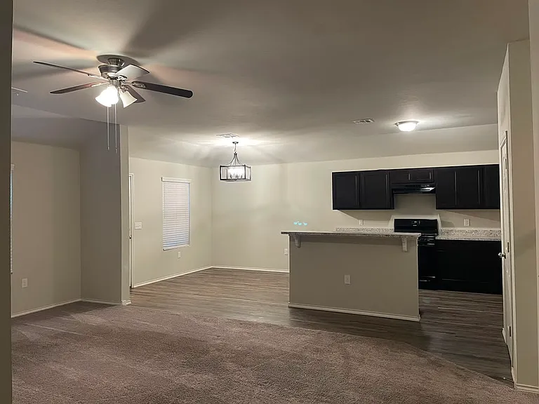 Open kitchen and dining area with a modern chandelier