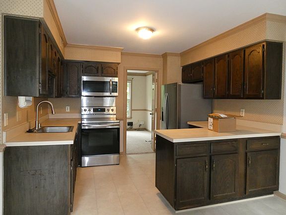 Kitchen with lots of cabinets, counter space, stainless steel appliances and new flooring