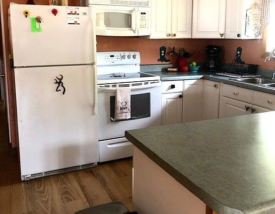 Kitchen includes refrigerator, stove, dishwasher and microwave. Heavy wood cabinets offer plenty of kitchen storage. Not shown is a hall pantry.
