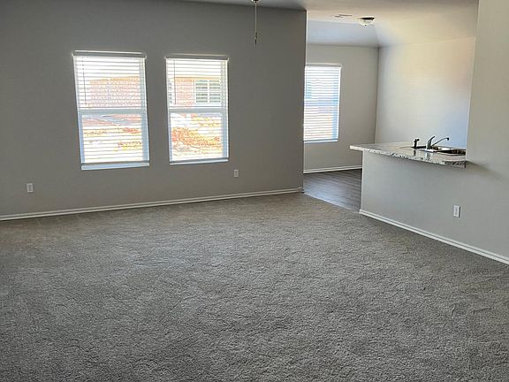 large living room with ceiling fan.