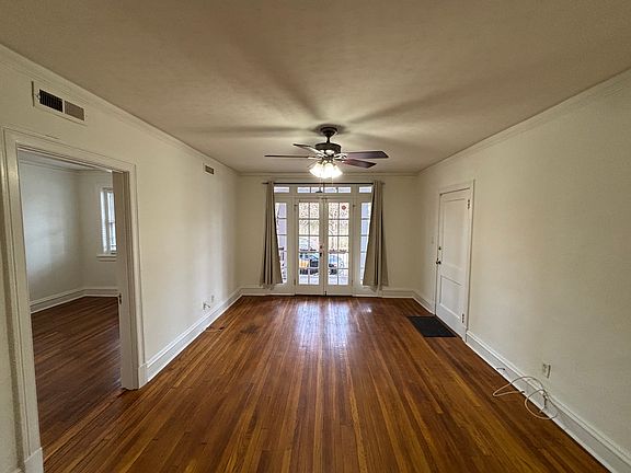 Living Room with French doors leading to dedicated porch with ceiling fan