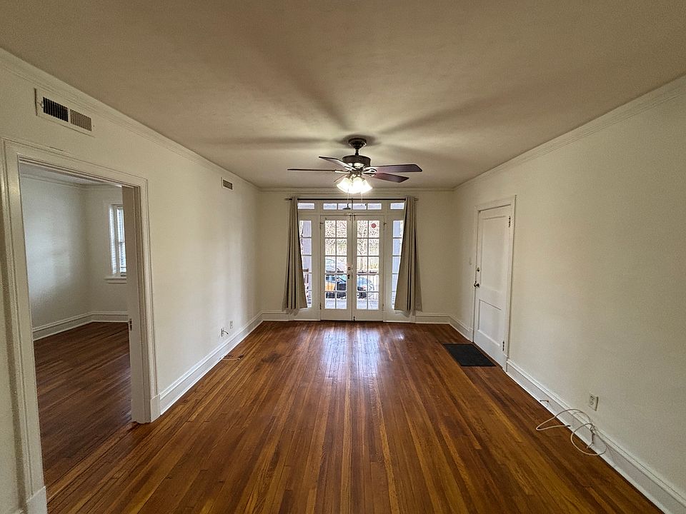 Living Room with French doors leading to dedicated porch with ceiling fan