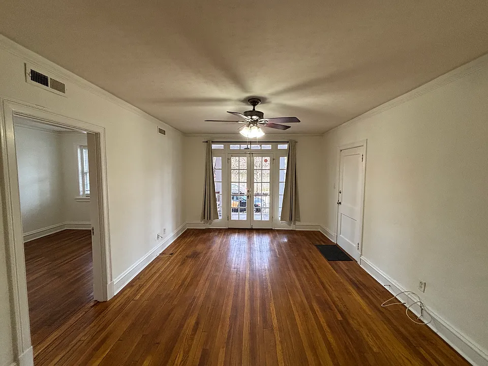 Living Room with French doors leading to dedicated porch with ceiling fan