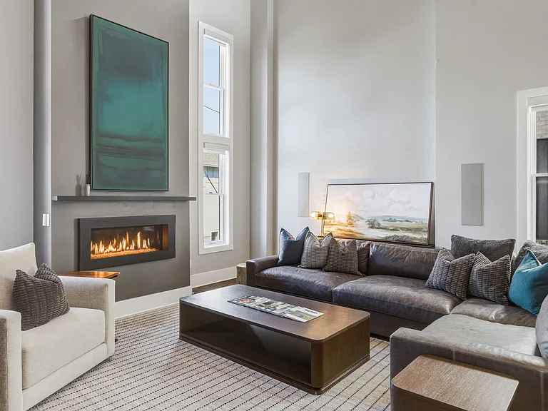 Bright, modern living room with HUGE ceilings. Abundant natural light, plush seating for everyone, a cozy gas fireplace, and a Smart TV_perfect for relaxing.
