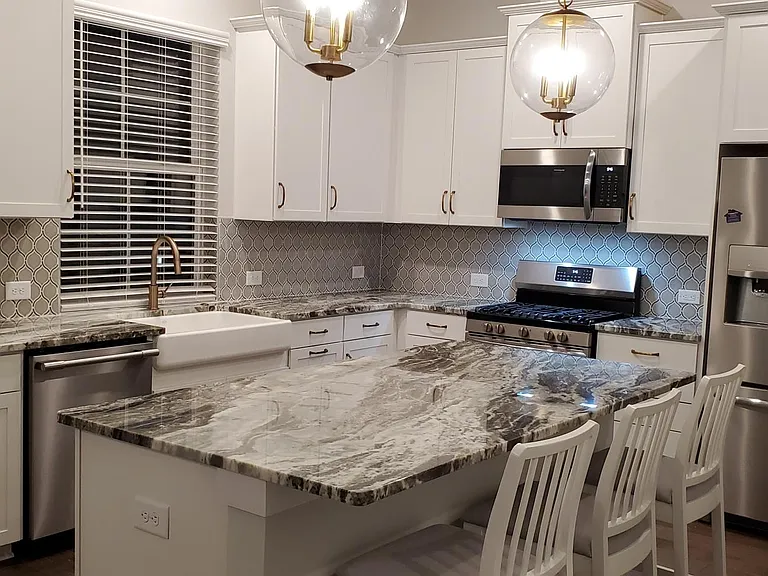 kitchen with granite countertop , nicely designed back splash.