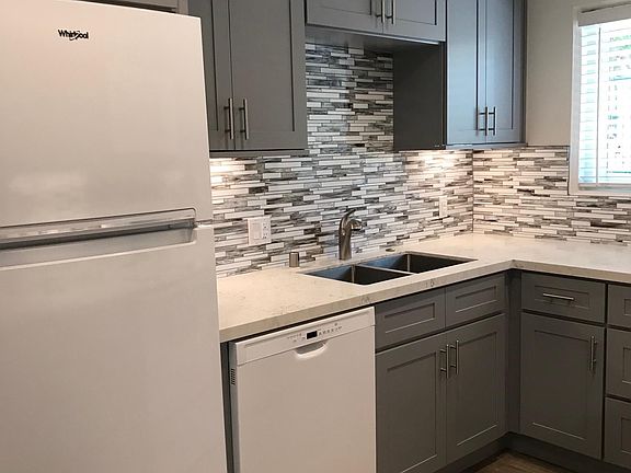 Kitchen with dishwasher, soft-close cabinets.