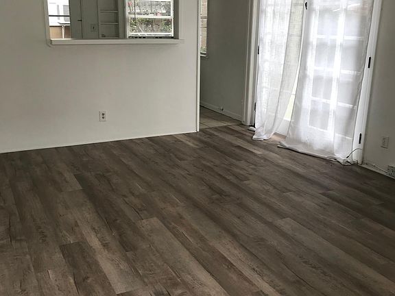 Living room with French doors to patio. Floor is slighter lighter than shows.