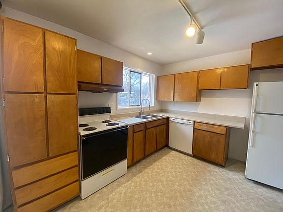 A spacious, cozy kitchen with new paint and a fresh floor.