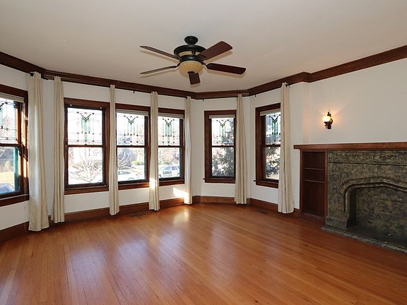 Leaded glass windows surround this large living room