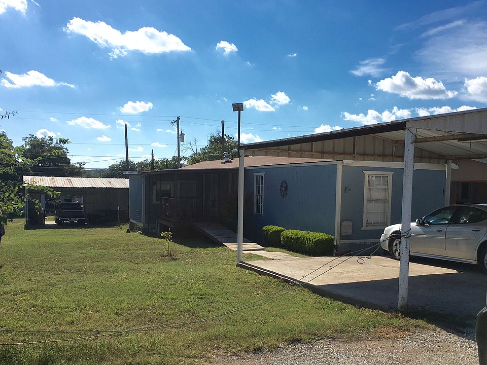 Carports, yard, and home. 