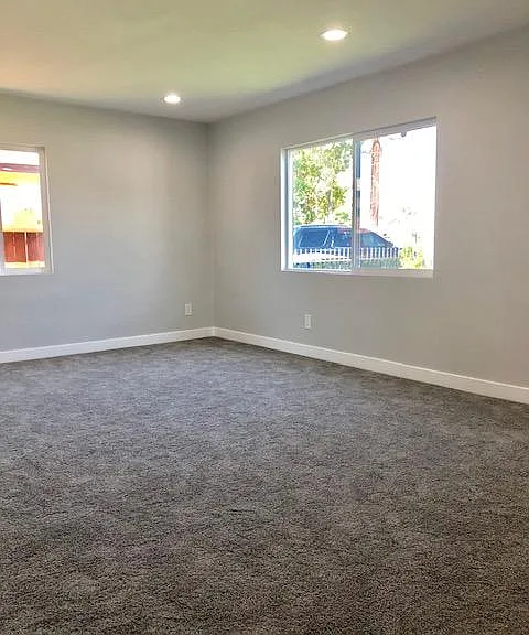 Living Room with new carpet, new windows, recessed lighting and new paint
