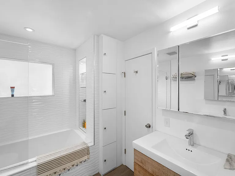 Jack n Jill bath, has two sink vanities. Door to second bedroom in back.