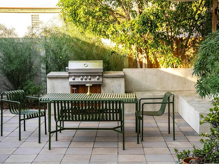 Outside dining area with built in BBQ and bench