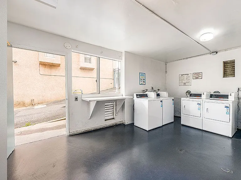 Clean on-site laundry room supporting both coin and app payment.