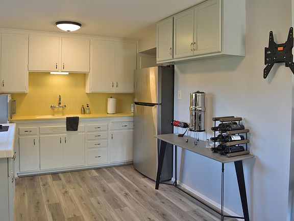 Your kitchen with new plank flooring and freshly painted cabinets