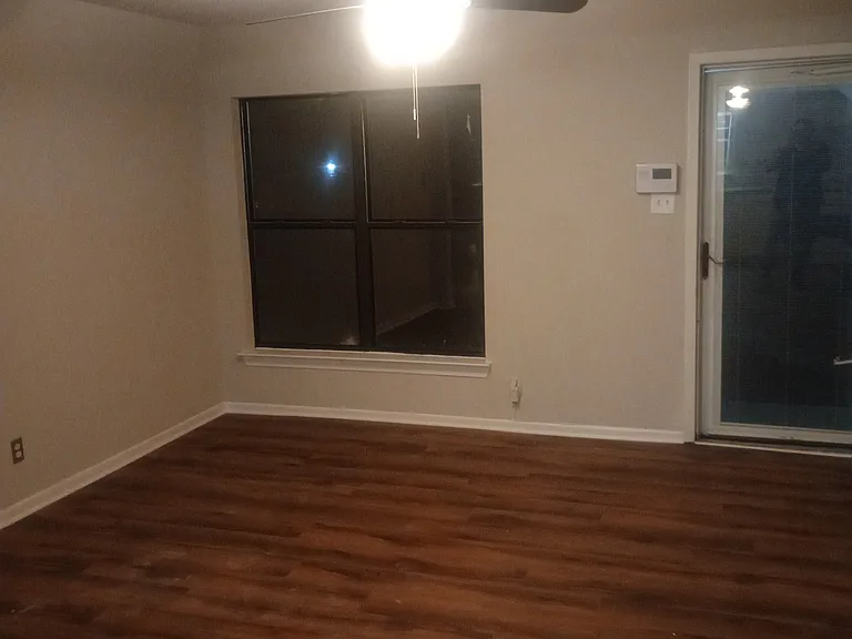 Front living area off the front door. Completely remodeled with laminate flooring and ceiling fan.
