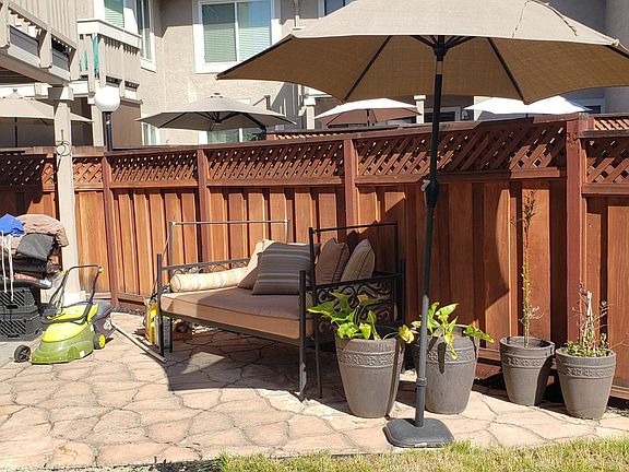 Outdoor sofa and umbrella available for use.