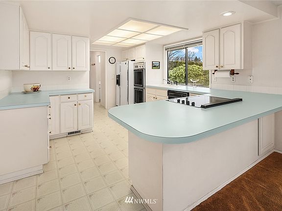 Spacious kitchen overlooks the backyard.