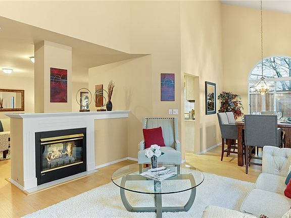 Pass through gas fireplace between the formal living room and great room is perfect for Winter warmth!  High above there's a ceiling fan to keep you cool in the Summers!