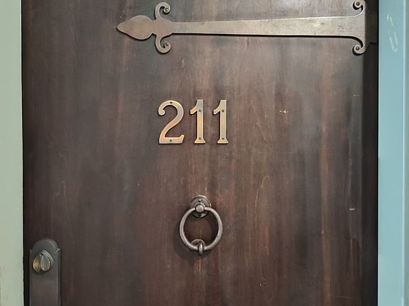 Unit door with charming hardware accents and door knocker