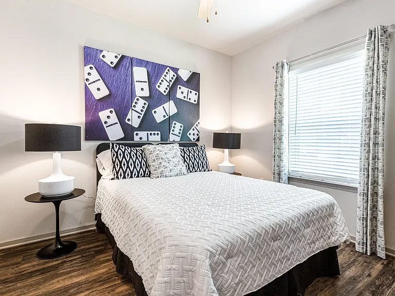 Bedroom with wood-designed flooring and window