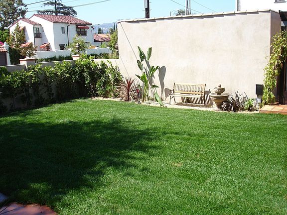 View of backyard and 2 car detached garage
