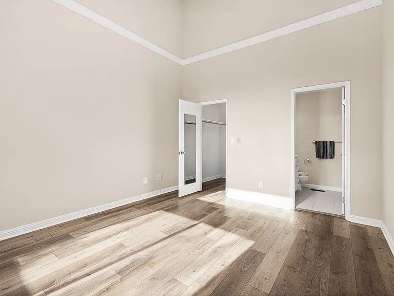 Master/Primary bedroom with vaulted-ceiling.