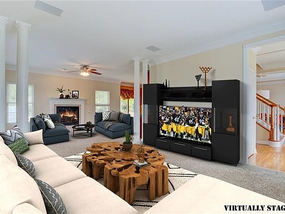 The 14'x13' Living Room is open to but separated from the Family Room by four beautiful pillars. The crown molding adds an elega