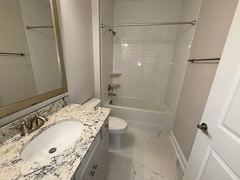 Hall Bath with Upgraded Tile and Granite Vanity Top