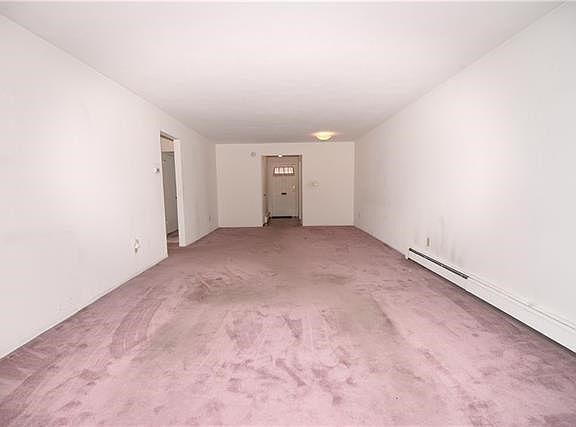 Another view of the living-room & dining-room area looking towards the main entrance to the unit.