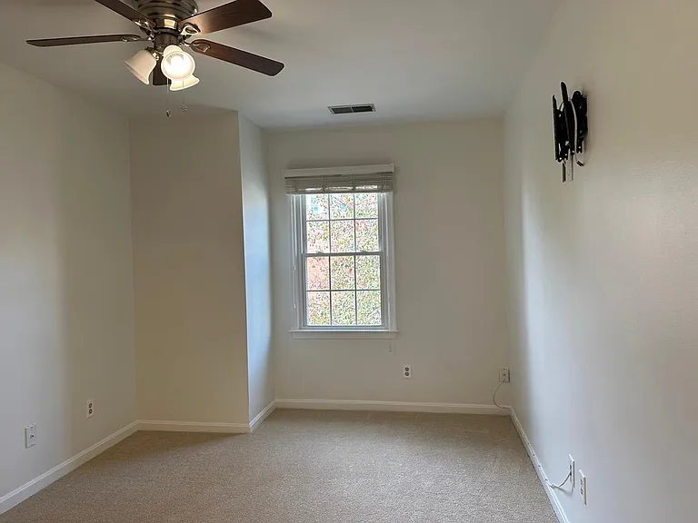 Primary Bedroom w/ ceiling fan and TV Mount