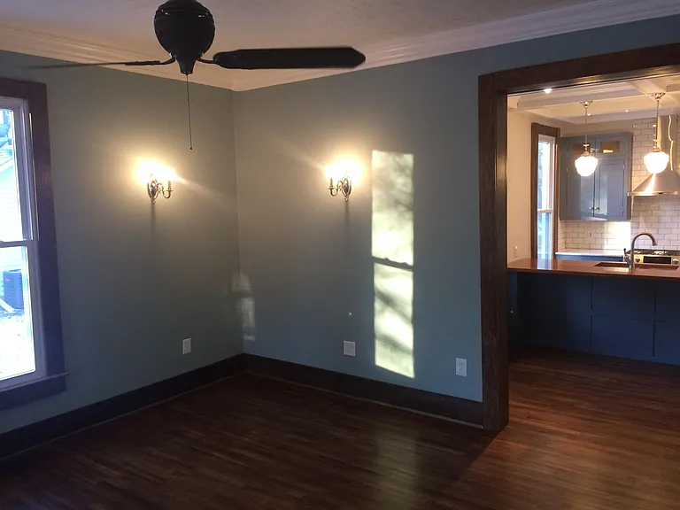 family room, with solid cast iron turn of the century ceiling fan & solid white oak flooring
