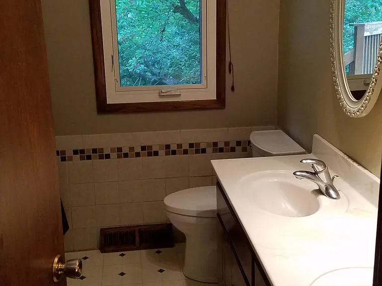 Main floor double vanity full bathroom with medicine cabinet
