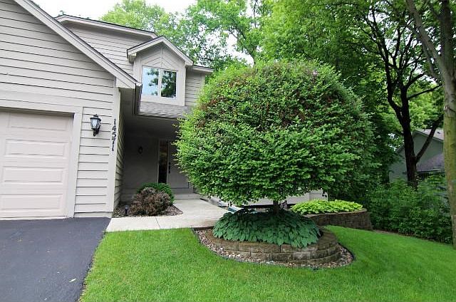Lushly manicured, the heavily wooded lot envelopes this fine home...