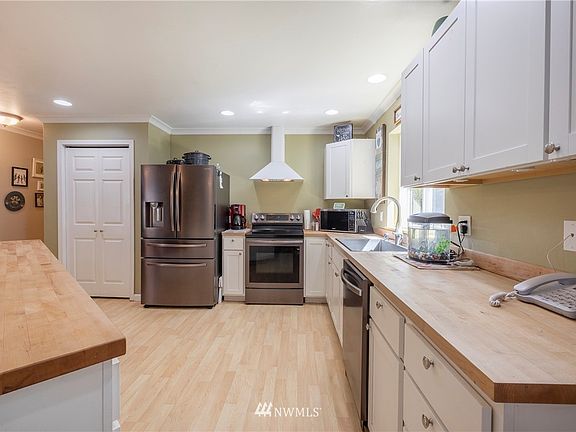 This well appointed kitchen is easy to work in. Deep kitchen sink and stainless steel appliances look sharp!