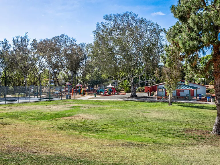 Community amenities include a basketball court, children's playground, and a large open lawn ideal for sports, picnics, and play.