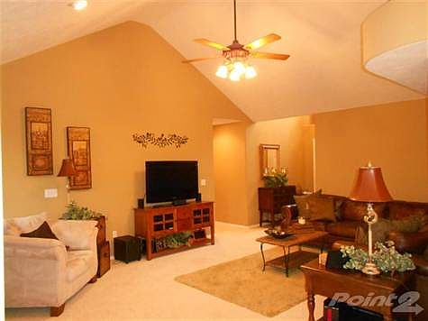 Tall ceilings give this a great open feel. The warm colors make it feel "homey".