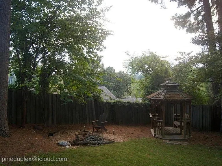 Spacious backyard with gazebo, firepit, patio, and plenty of space for a small garden.