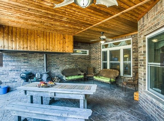 Covered patio w/ vent-hood for grilling
						:
						Enjoy sitting outdoors during rain showers. Custom vent-hood for year-round fun