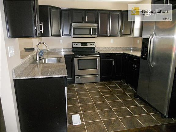 Beautiful kitchen with custom cabinets, stainless appliance, tile floor and granite countertops!