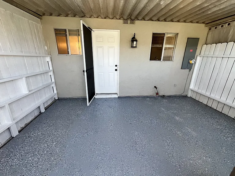 private back yard patio looking towards back doo of the home. Great for relaxing, bikes, etc