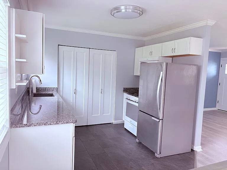 Kitchen View 2, New Windows, New Lighting, Washer/Dryer located behind bi-fold doors