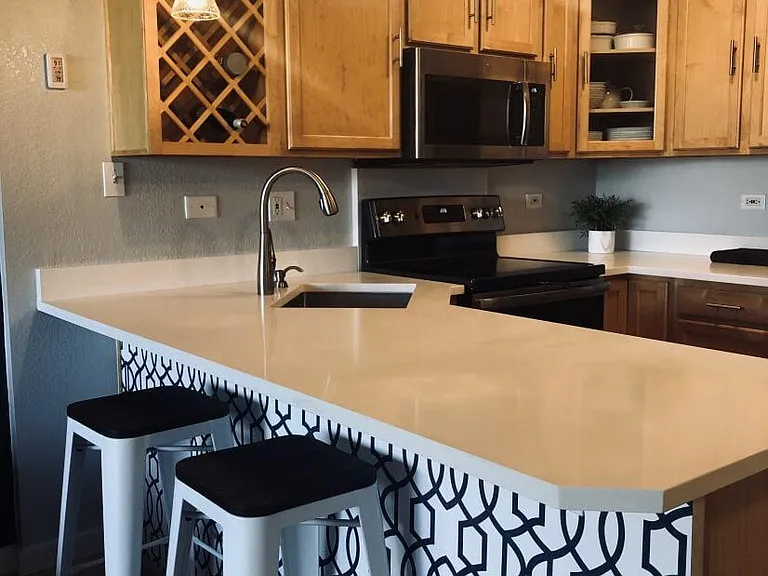 New quartz countertops and stainless steel appliances.