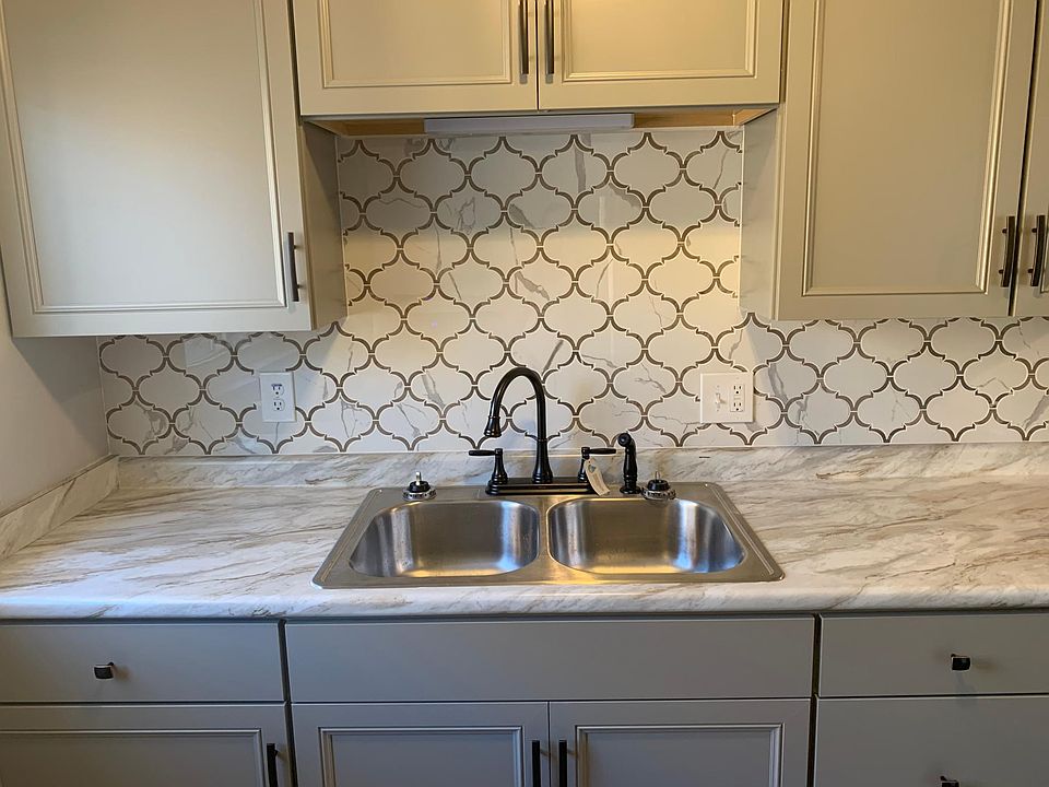 Mosaic tile backsplash, new cabinets, sink and oil-rubbed bronze hardware.