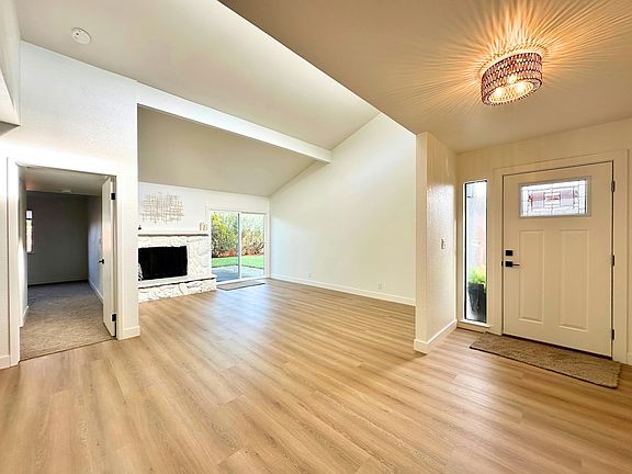 View from Kitchen of Living Room and Entry, and door to Primary Bedroom