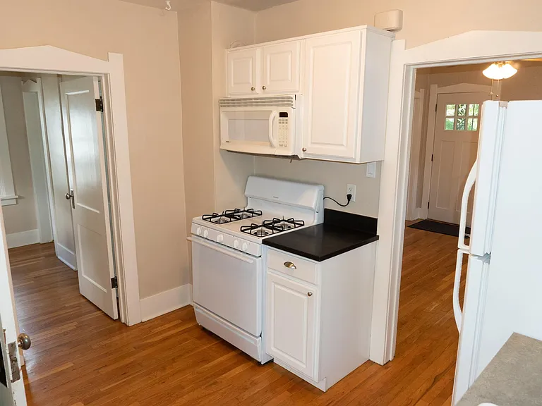 Kitchen view from the sink. The entrance to the back bedroom is in on the left. The living room entrance is on the right.